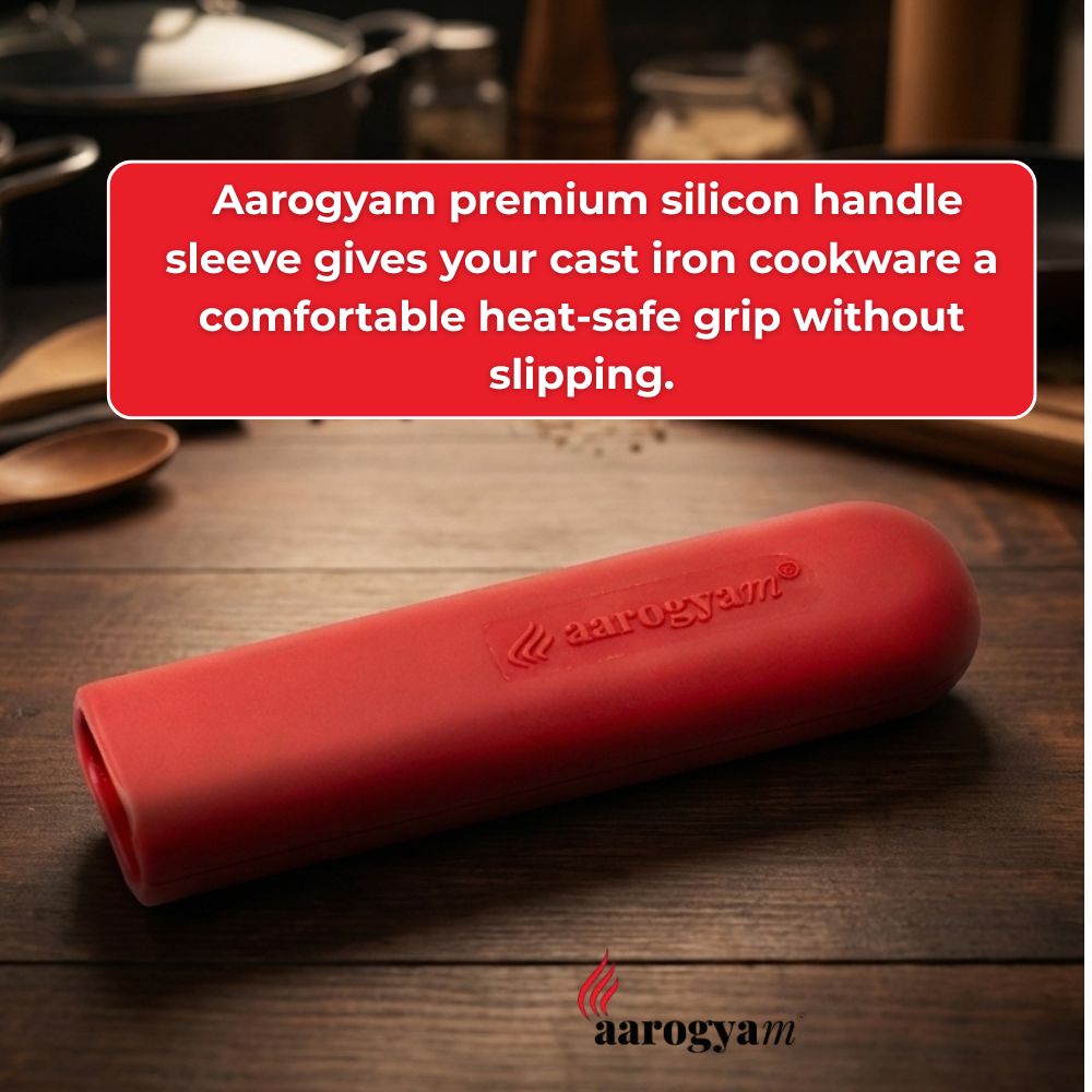 Red Aarogyam silicone handle sleeve on a wooden surface with text about its features.