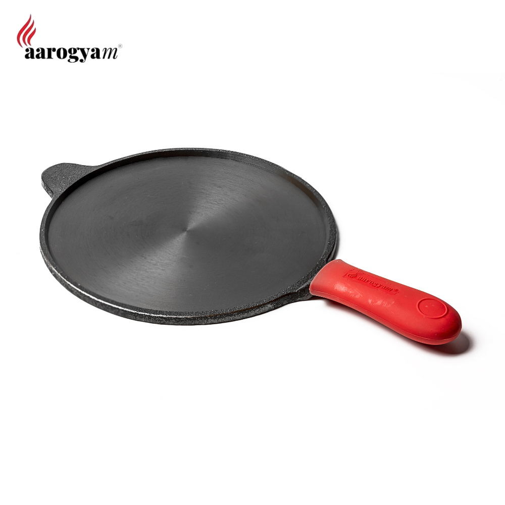 Black frying pan with red handle on a white background, featuring the Aarogyam brand.
