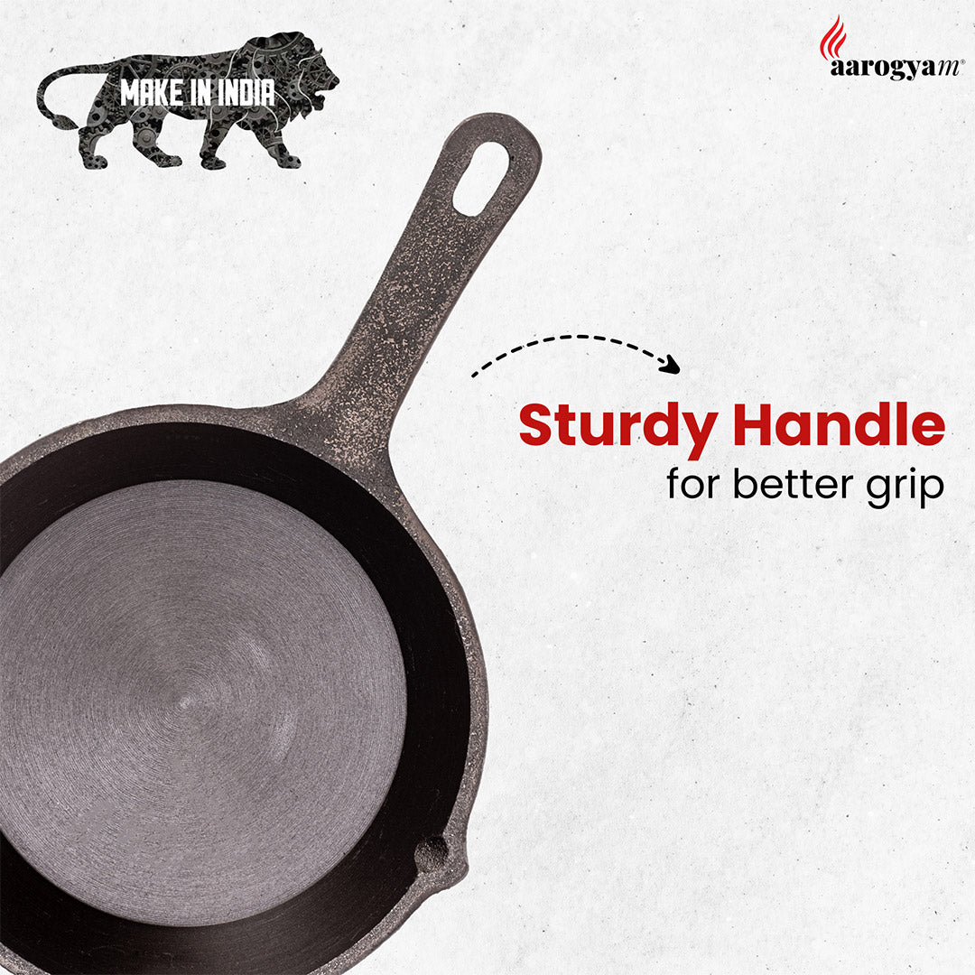 Cast iron skillet with a sturdy handle on a white background, featuring 'Make in India' and 'aarogyaTV' logos.