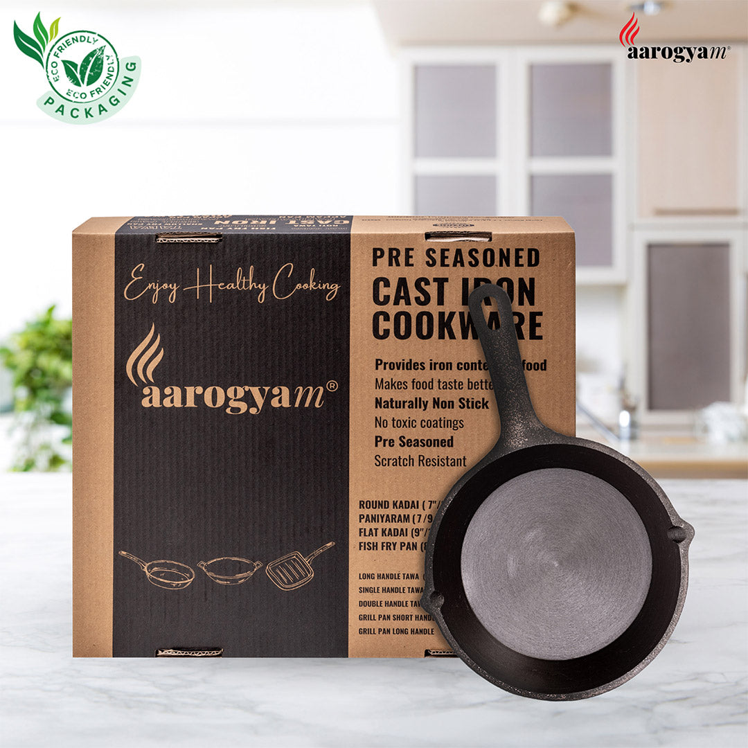 Pre-seasoned cast iron cookware with arogyam packaging in a kitchen setting