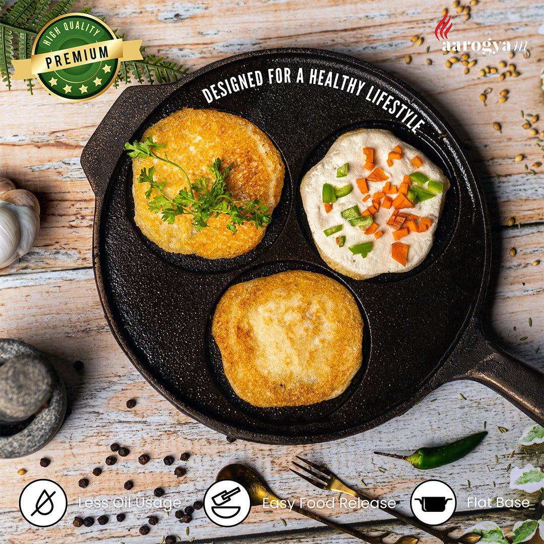 Black cast iron skillet with food on a wooden surface, featuring Arogya brand.